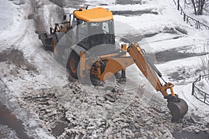 Excavator cleans street