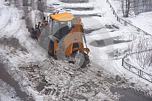 Excavator cleans street