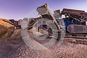 Excavator collecting stone in an open-cast mine