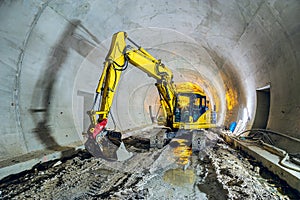 Excavator in construction place of building new railway tunnel.