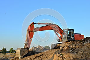 Excavator at a construction site during earthworks and laying of underground pipes. Professional excavation contractor serving,