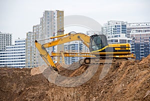 Excavator at construction site during laying sewer and main reticulation systems.