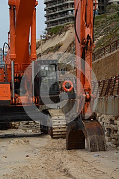 Excavator on construction site, Excavator Loader standing in sandpit with pulled down bucket