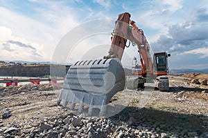 Excavator at the construction site of a road