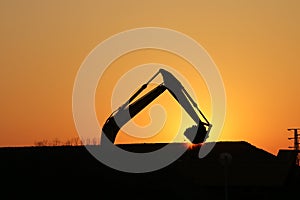 Excavator on construction site silhouette