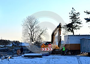 excavator on a construction site in the winter. Danger zone, no entry allowed
