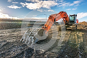 Excavator on the construction works of a road