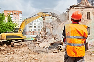 Excavator crasher machine at demolition on construction site