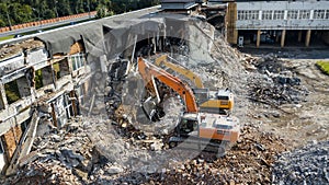 Excavator demolish building. Drone view photo