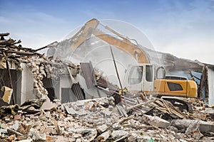 Excavator demolishing barracks