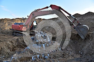 Excavator on demolition the old building. Backhoe the destruction of concrete and hard rock. Recycling of construction waste at