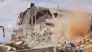 Excavator destroys abandoned hockey arena at demolition work