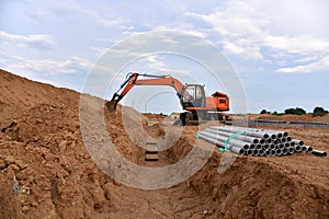 Excavator dig the trenches at a construction site. Trench for laying external sewer pipes. Sewage drainage system for a multi-