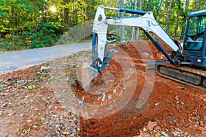 Excavator dig trenches for laying pipes to transport rainwater to a collectors