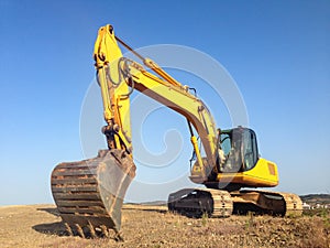 Excavator, digger with blue sky