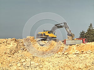 Excavator digger stone and Dump truck working on hill