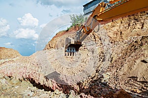 Excavator digging a hole. Earthwork