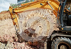 Excavator digging a hole. Earthwork