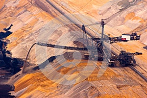 Excavator digging lignite in open-cast mine