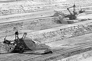 Excavator digging lignite in open-cast mine