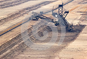Excavator digging lignite in open-cast mine