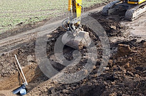 Excavator digging trench photo