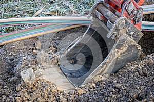 Excavator digging a trench to lay a high-speed Internet DSL cable