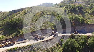 Excavator digs a mountain to widen the road