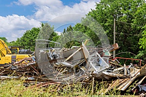 Excavator of dismantling the rubble after demolition of the house