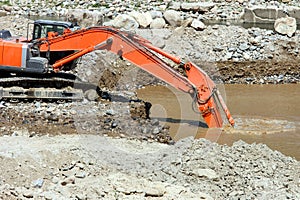 Excavator dredging sediment mud