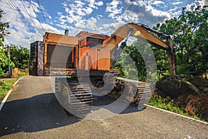 Excavator dredging in small canal