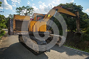 Excavator dredging in small canal