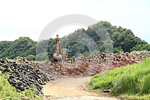 Excavator on dump