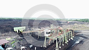 Excavator and dump truck at Open pit coal mining aerial view