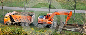 Excavator and dump truck. work on the arrangement of tracks