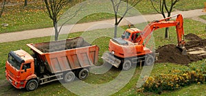 Excavator and dump truck. work on the arrangement of tracks