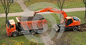 Excavator and dump truck. work on the arrangement of tracks