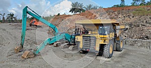 Excavator and Dump truck working in coal mine project