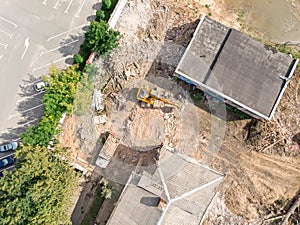 Excavator and dump truck working at demolition site. aerial view