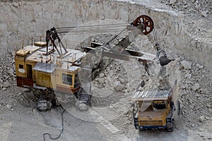 Excavator and dump truck working and extracting the chalk in a q