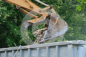 Excavator dumps waste