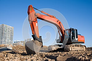 Excavator during earthmoving at construction site. Backhoe digg ground at construction site for the construction of the road and
