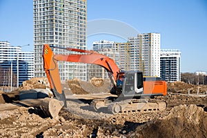 Excavator during earthmoving at construction site. Backhoe digg ground at construction site for the construction of the road and