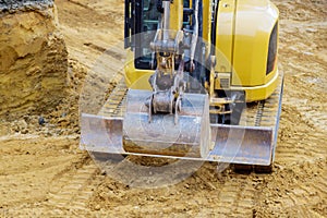 Excavator on earthwork during the foundation construction