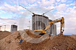 Excavator on earthworks at construction site. Backhoe on road work and laying sewer pipes. Construction machinery for dig ground,