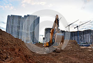 Excavator on earthworks at construction site. Backhoe on road work and laying sewer pipes. Construction machinery for dig ground,