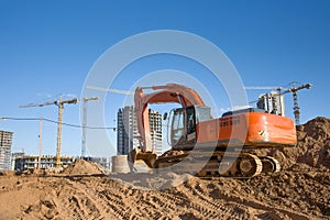 Excavator on earthworks for laying heating pipes and stormwater in trench. Installing concrete wells, Ñhambers, manholes near new