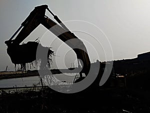 Excavator ecavating construction site silhouette image