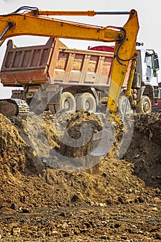 Excavator and empty dump truck
