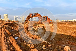 Excavator during excavation at construction site.  Backhoe on Earthworks. Heavy Construction Equipment Machines in Action. Big